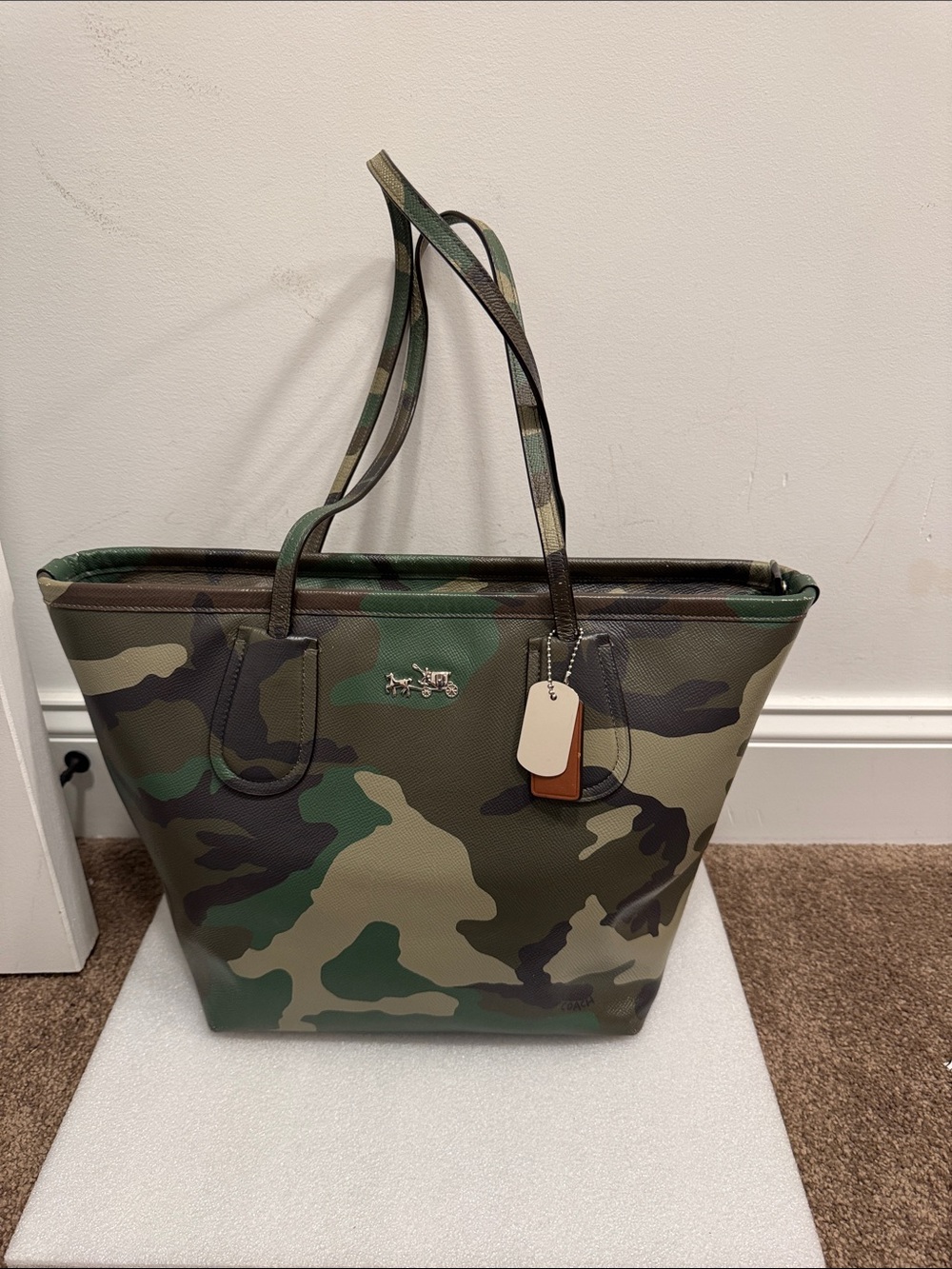 Coach taxi zip tote bag in camouflage pattern with metal hangtag